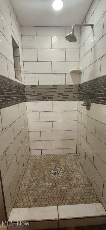 bathroom with tiled shower