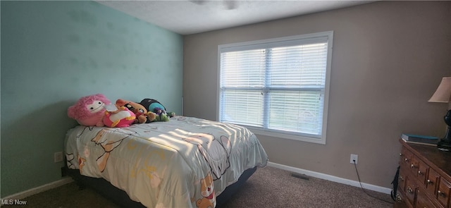 bedroom featuring dark colored carpet