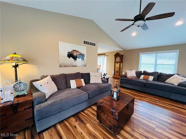 living room featuring ceiling fan, high vaulted ceiling, and light hardwood / wood-style flooring