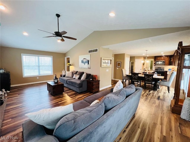 living room featuring vaulted ceiling, wood-type flooring, and ceiling fan