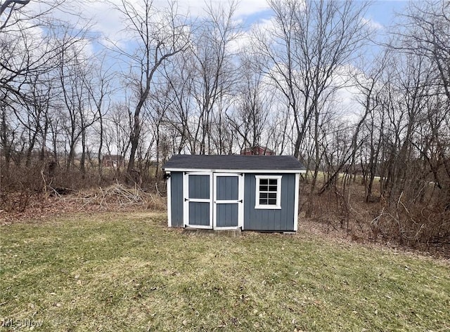 view of outbuilding with a yard