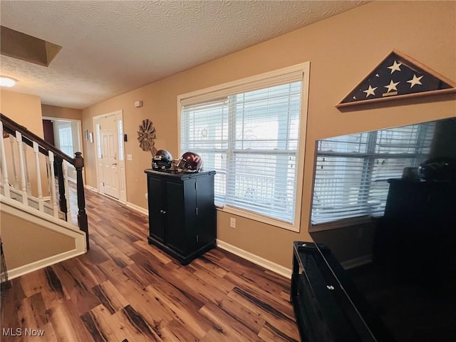 entryway featuring dark hardwood / wood-style floors and a textured ceiling