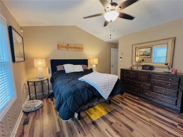 bedroom featuring vaulted ceiling, ceiling fan, and light wood-type flooring