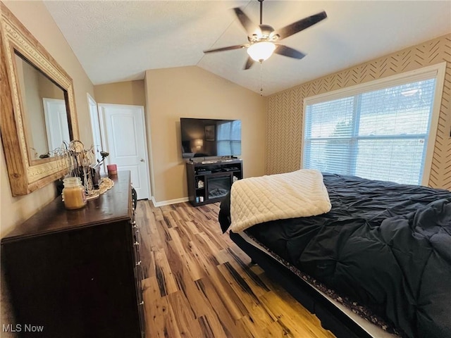 bedroom featuring vaulted ceiling, ceiling fan, and light hardwood / wood-style flooring