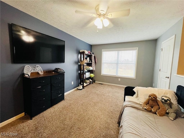 bedroom featuring ceiling fan, carpet flooring, and a textured ceiling