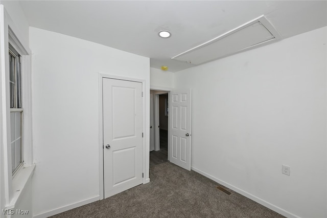 unfurnished bedroom featuring dark carpet