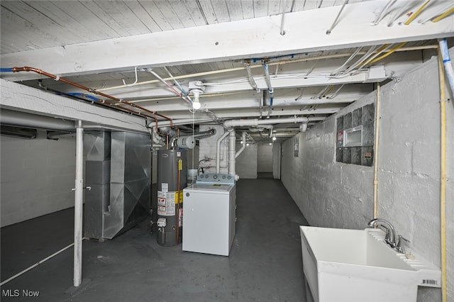 basement with washer / clothes dryer, water heater, and sink