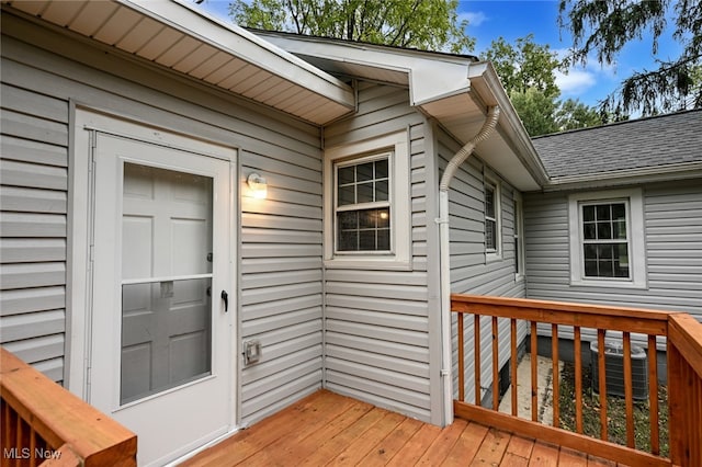 property entrance featuring cooling unit and a deck