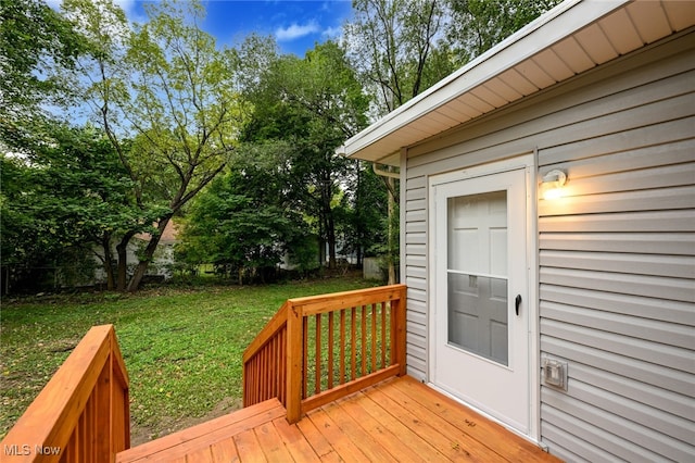 wooden terrace featuring a yard