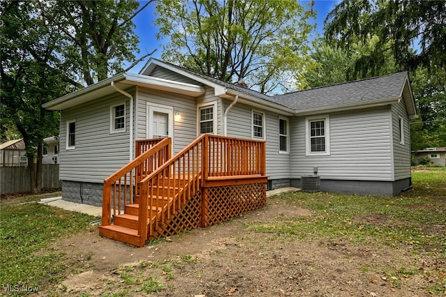 rear view of house featuring cooling unit