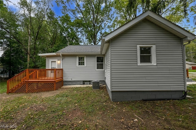 back of house featuring central AC unit and a deck