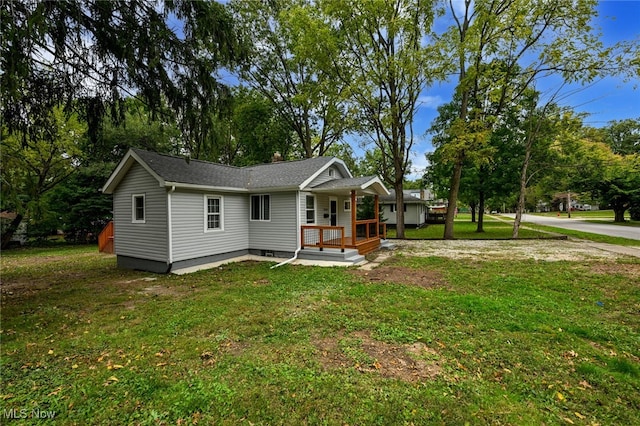 ranch-style home with a front yard and a porch