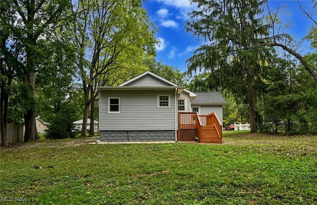 rear view of property featuring a lawn and a patio