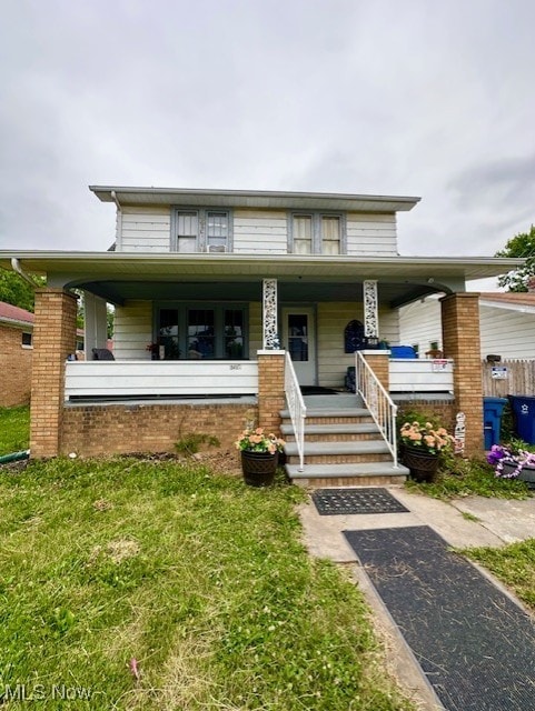 view of front of property featuring a front lawn and covered porch