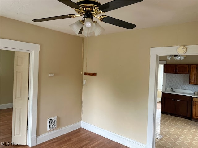 spare room featuring ceiling fan and light wood-type flooring