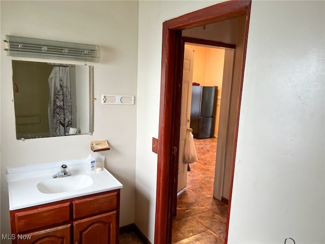 bathroom featuring tile patterned flooring and vanity