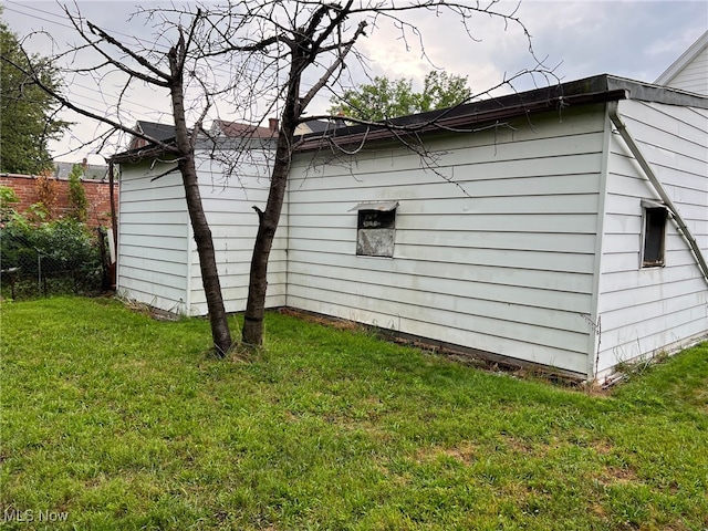 view of side of home with a yard