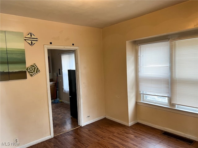 empty room with dark wood-type flooring