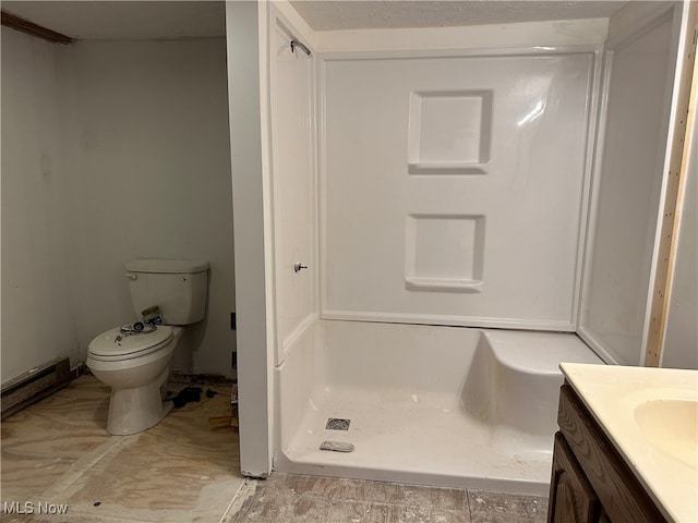 bathroom featuring a shower, vanity, and toilet