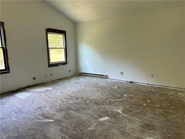 spare room featuring vaulted ceiling, a textured ceiling, and baseboard heating