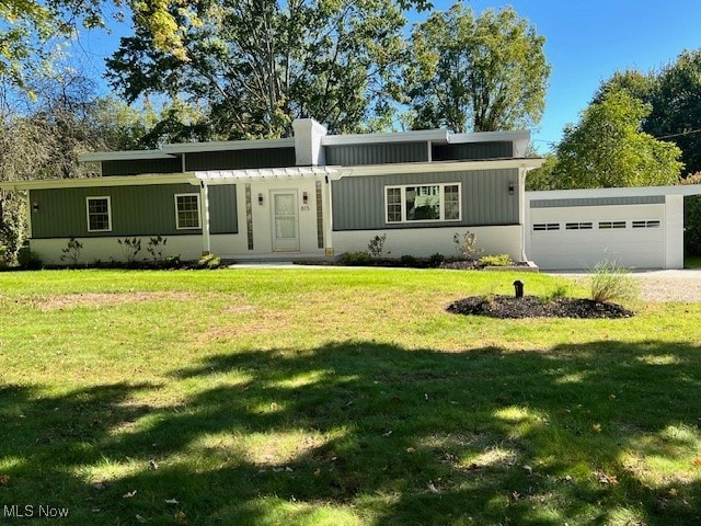 ranch-style home with a front yard and a garage