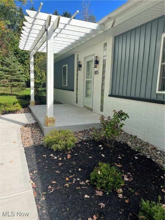 property entrance with a patio and a pergola