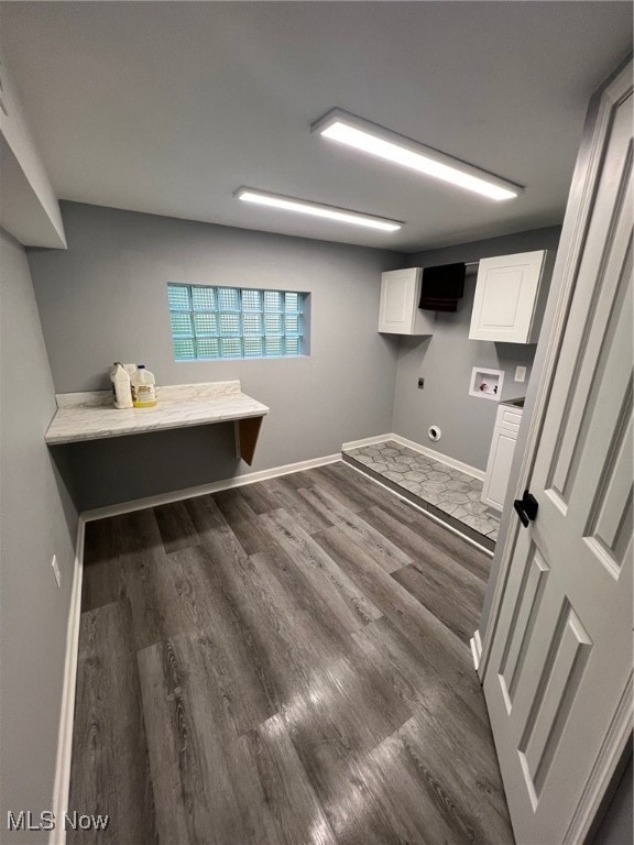 washroom with hookup for an electric dryer, washer hookup, cabinets, and dark hardwood / wood-style flooring