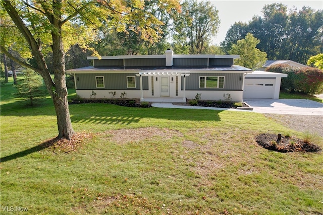 view of front of home with a garage, a front lawn, and covered porch