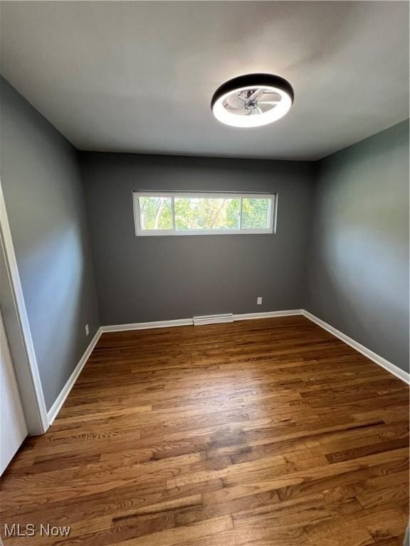 spare room featuring wood-type flooring