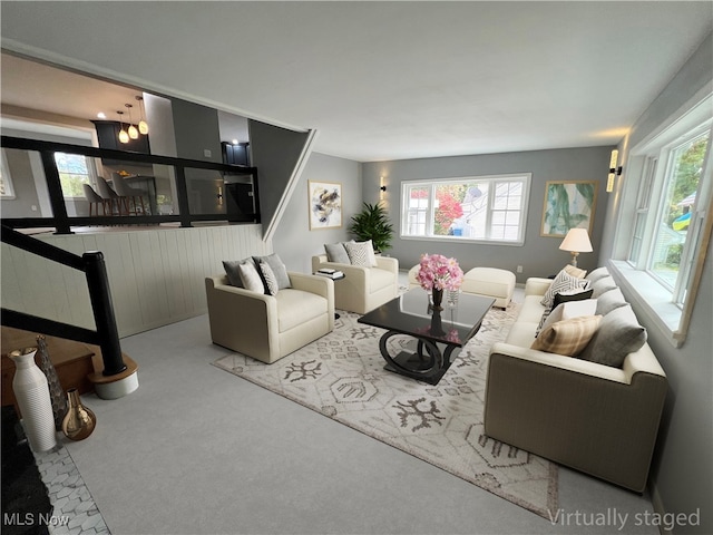 living room featuring light carpet and a healthy amount of sunlight