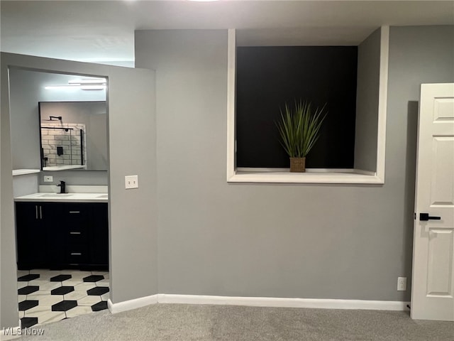 corridor with sink and light colored carpet