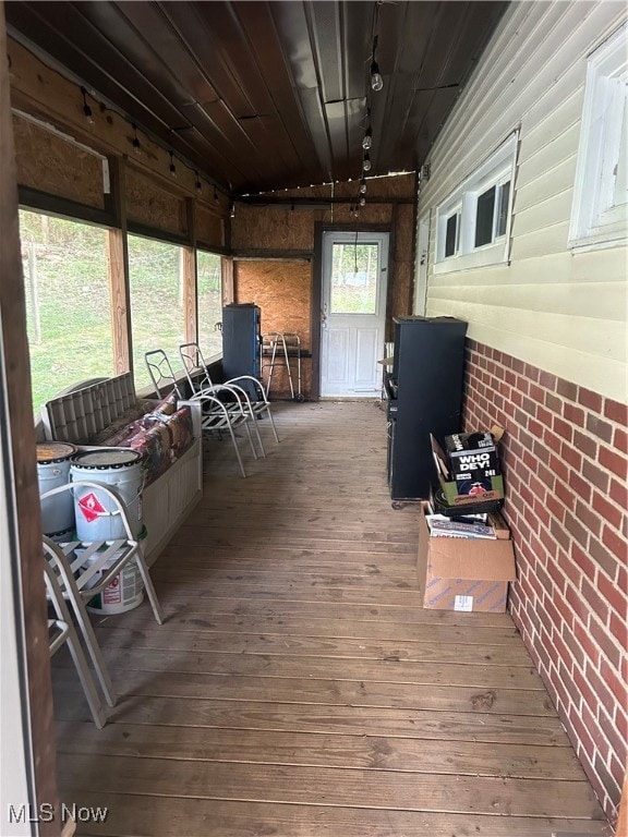 sunroom / solarium featuring track lighting