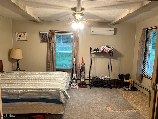 bedroom with ceiling fan, carpet floors, multiple windows, and a wall unit AC