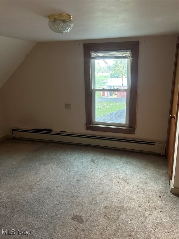 additional living space featuring lofted ceiling, baseboard heating, and light colored carpet