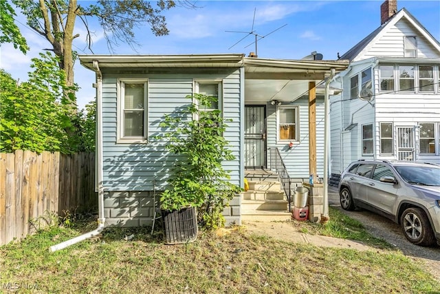 view of front of home featuring fence