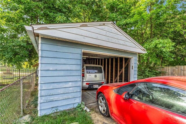 detached garage featuring fence