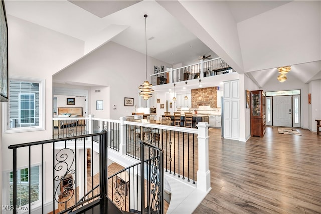 interior space featuring wood-type flooring, high vaulted ceiling, and ceiling fan