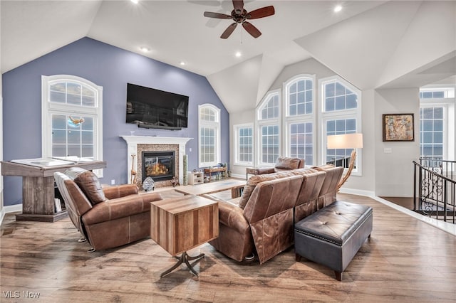 living room featuring vaulted ceiling, ceiling fan, and hardwood / wood-style floors