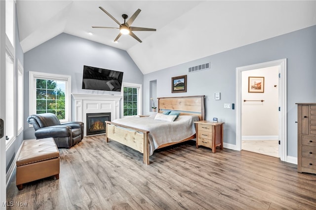 bedroom with lofted ceiling, light hardwood / wood-style floors, and ceiling fan