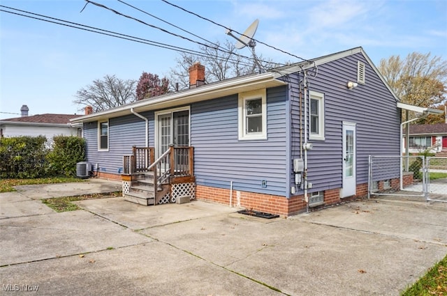 back of house with central AC unit