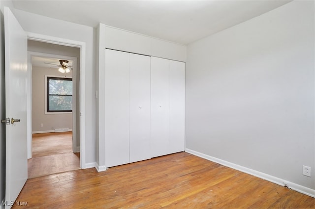 unfurnished bedroom with light hardwood / wood-style floors and a closet