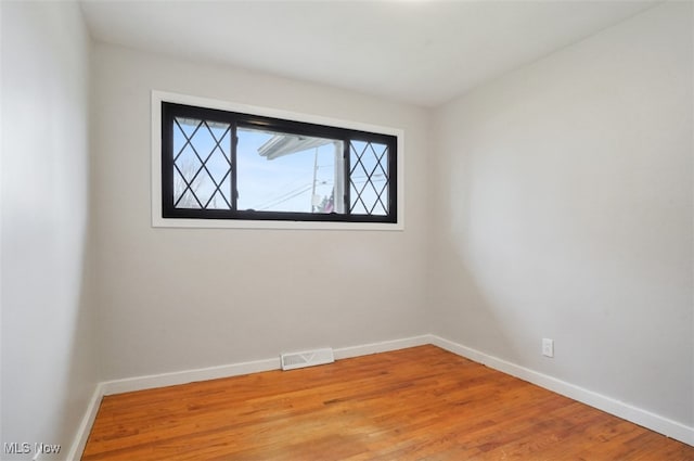 spare room with hardwood / wood-style flooring