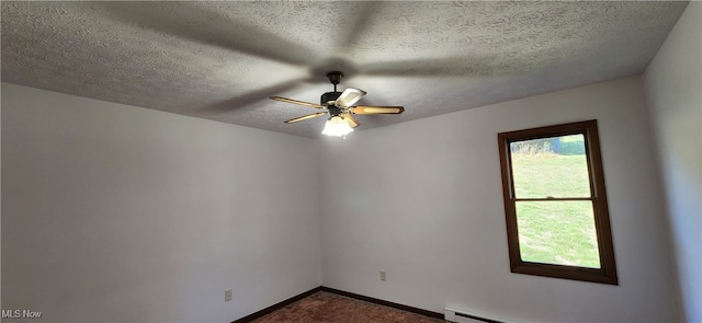 unfurnished room with a textured ceiling, ceiling fan, and a baseboard radiator