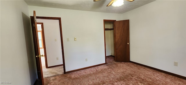 unfurnished bedroom featuring ceiling fan, a textured ceiling, and light carpet