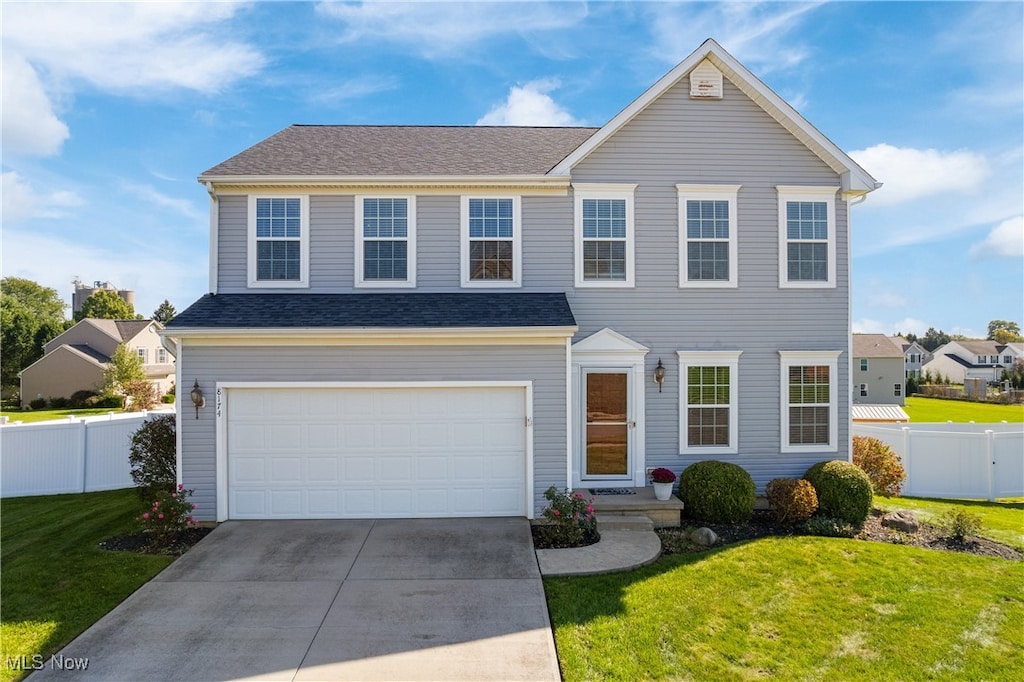 view of front of house featuring a garage and a front yard