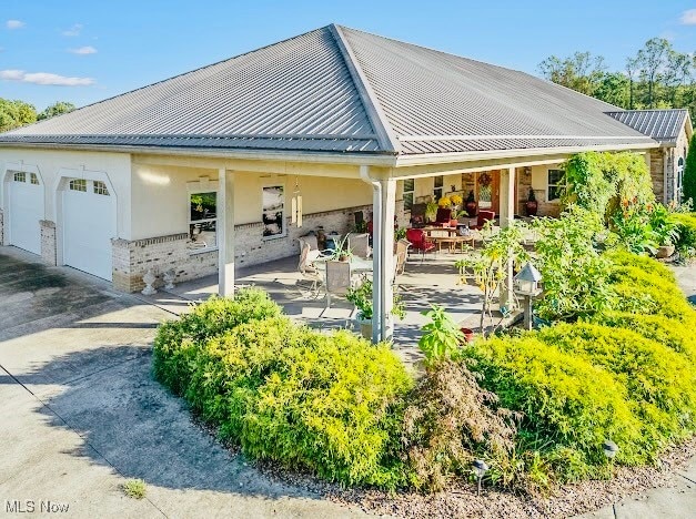 back of property featuring a garage and a porch