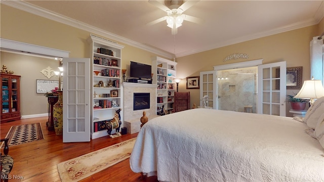 bedroom with ornamental molding, hardwood / wood-style flooring, ceiling fan, and french doors