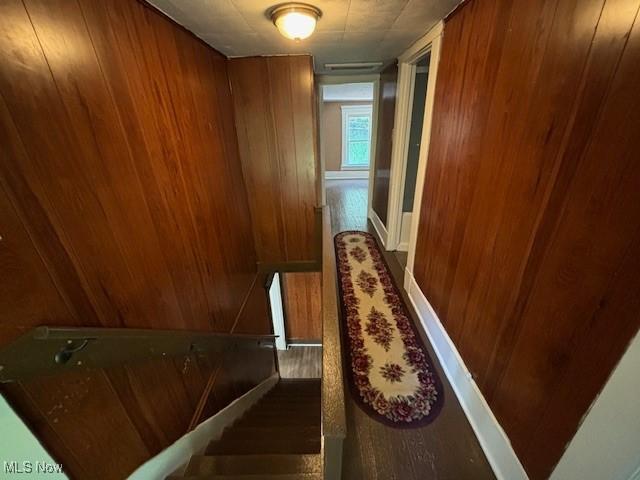805 Quarry St, Marietta, OH 45750 - hallway featuring wood finished floors, wood walls, and an upstairs landing