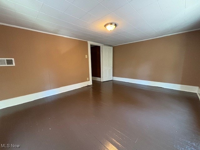 unfurnished room featuring crown molding