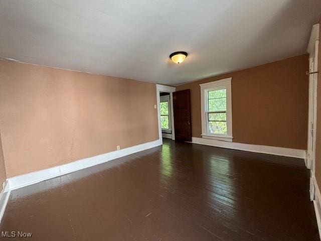 805 Quarry St, Marietta, OH 45750 - empty room with baseboards and dark wood-style flooring